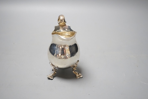 A George V silver cream jug, on tripod feet, William Comyns & Sons Ltd, London, 1928, 10.2cm, 5oz.